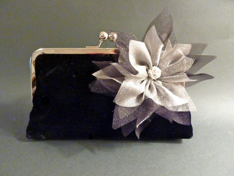 This hand-crated floral piece on this clutch really takes the clutch from classic to divine!